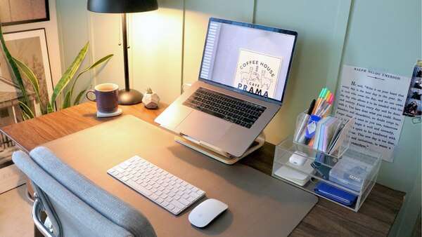 Open notebook and laptop on a clean desk with soft natural light